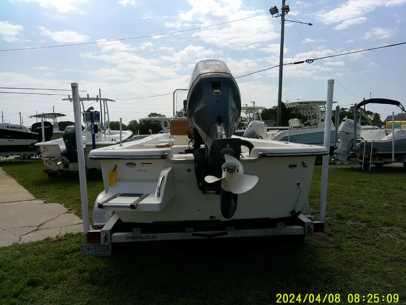 Slide: The Image of Sundance B22CCR 2015 boat on trailer, outdoor display, overcast sky. - 8