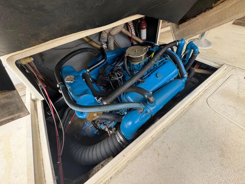 Slide: The Image of 1985 Blackfin 29 Combi Express engine compartment with blue marine engine. - 13