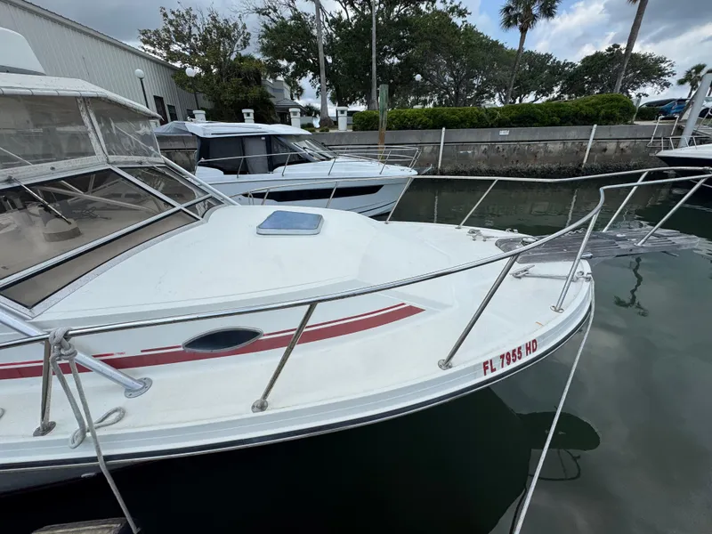 Slide: The Image of 1985 Blackfin 29 Combi Express boat docked in marina, featuring sleek design and white exterior. - 15