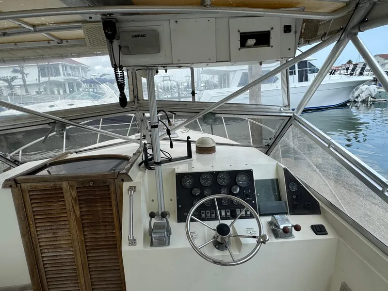 Slide: The Image of 1985 Blackfin 29 Combi Express boat cockpit with steering wheel and control panel. - 4