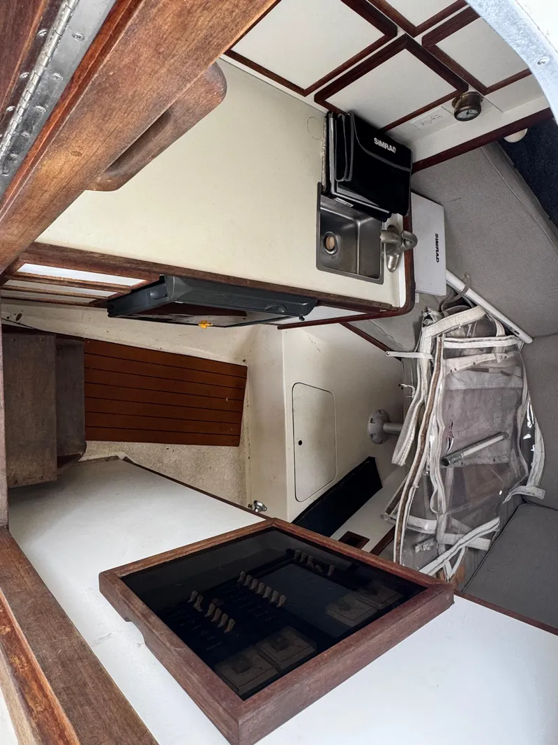 Slide: The Image of Interior of 1985 Blackfin 29 Combi Express boat with compact kitchen and seating area. - 5