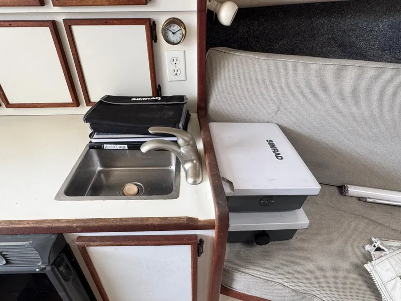 Slide: The Image of 1985 Blackfin 29 Combi Express interior with sink, cabinets, and seating area. - 6