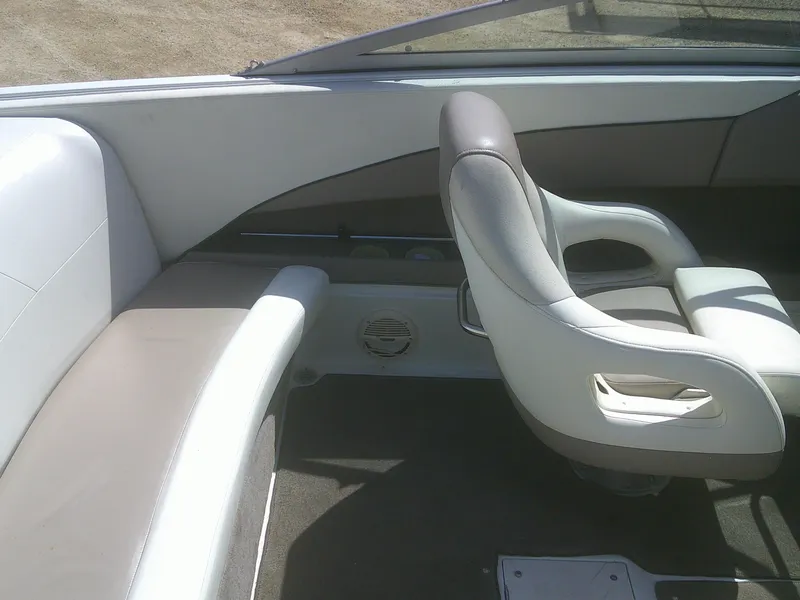 Slide: The Image of Interior of a 1998 Cobalt 220 boat featuring gray and white seating. - 13