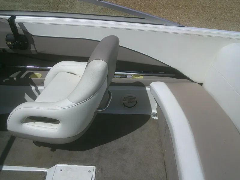 Slide: The Image of Interior of a 1998 Cobalt 220 boat featuring white seating and a steering console. - 14
