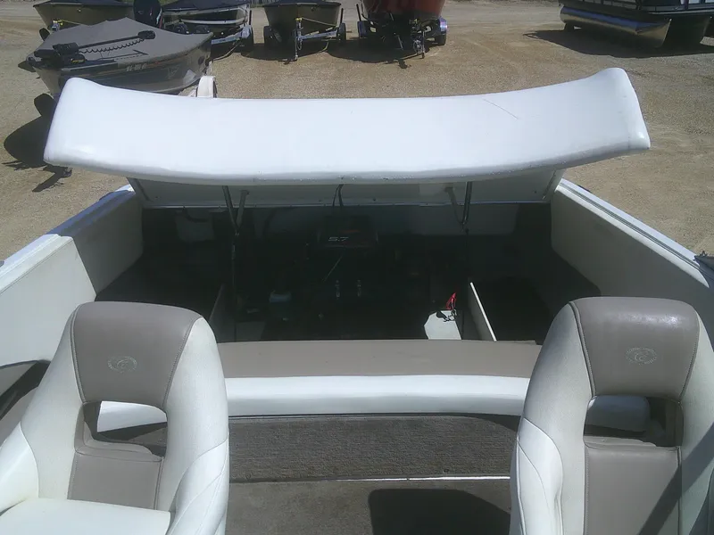 Slide: The Image of 1998 Cobalt 220 boat interior with open engine compartment and seating. - 15