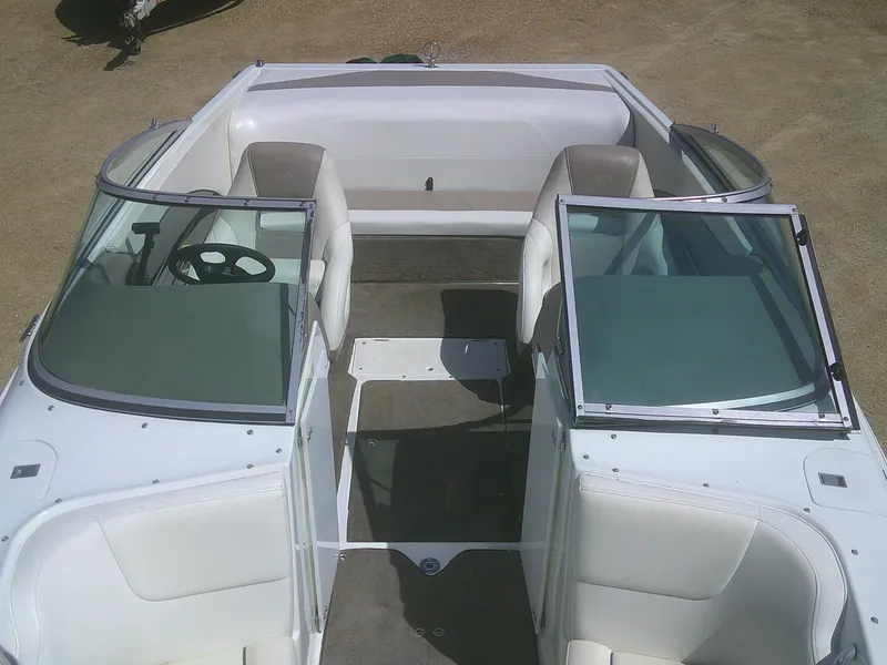 Slide: The Image of 1998 Cobalt 220 boat interior with white seating and open windshield. - 8