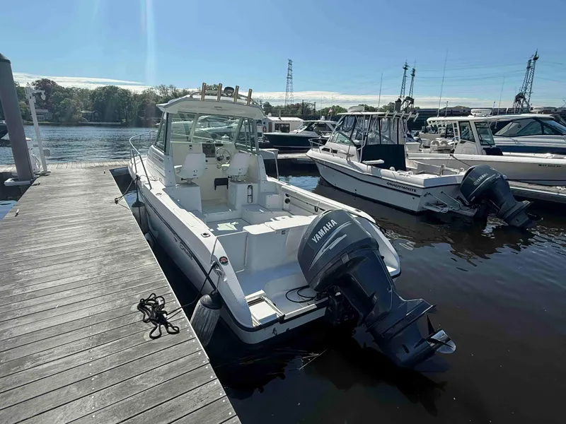 Slide: The Image of 2005 Seaswirl Striper 2601 Walkaround O/B docked, featuring Yamaha outboard motor. - 3