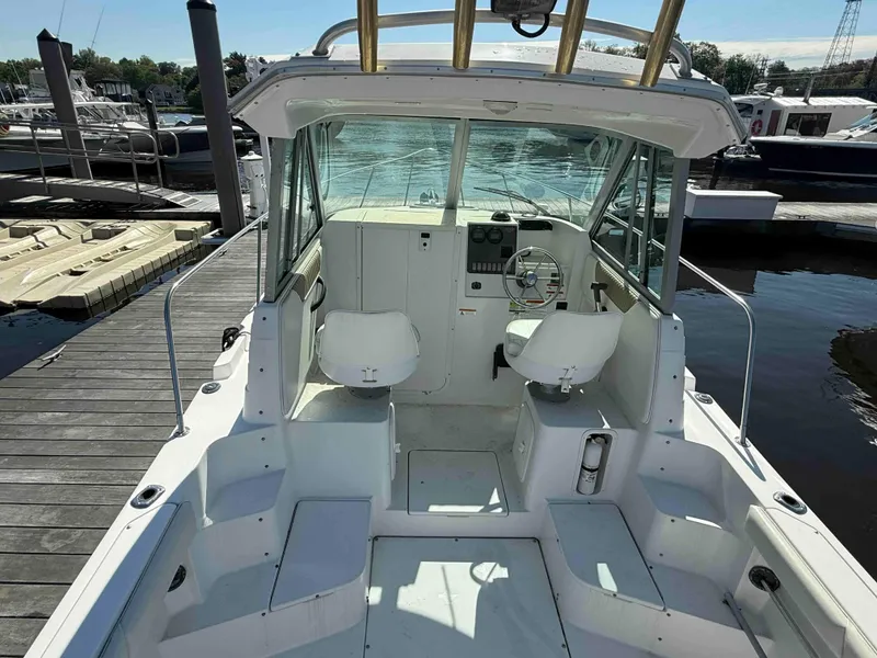 Slide: The Image of 2005 Seaswirl Striper 2601 Walkaround O/B boat docked at marina. - 4