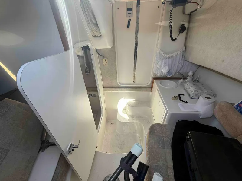 Slide: The Image of 2005 Seaswirl Striper 2601 Walkaround O/B cabin interior with compact amenities. - 6