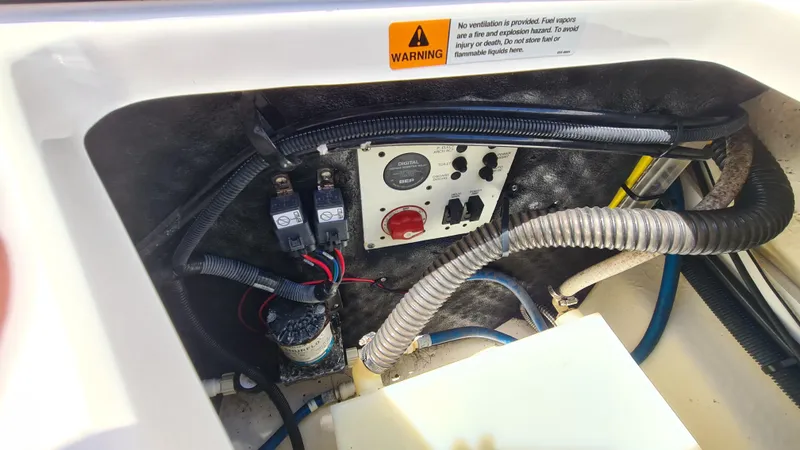 Slide: The Image of Electrical panel and wiring inside a 2018 Chaparral Suncoast 250 Deluxe boat. - 23