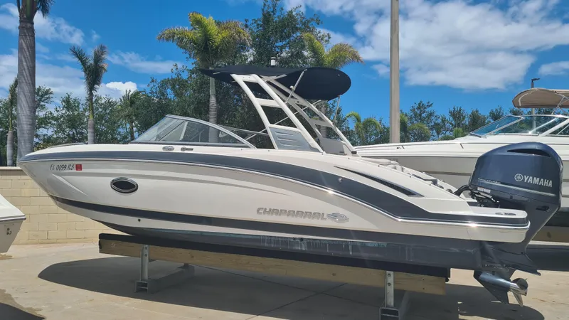 Slide: The Image of 2018 Chaparral Suncoast 250 Deluxe boat with Yamaha engine, docked under clear blue sky. - 3