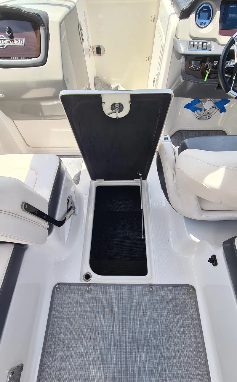 Slide: The Image of 2018 Chaparral Suncoast 250 Deluxe boat interior with open storage compartment. - 32