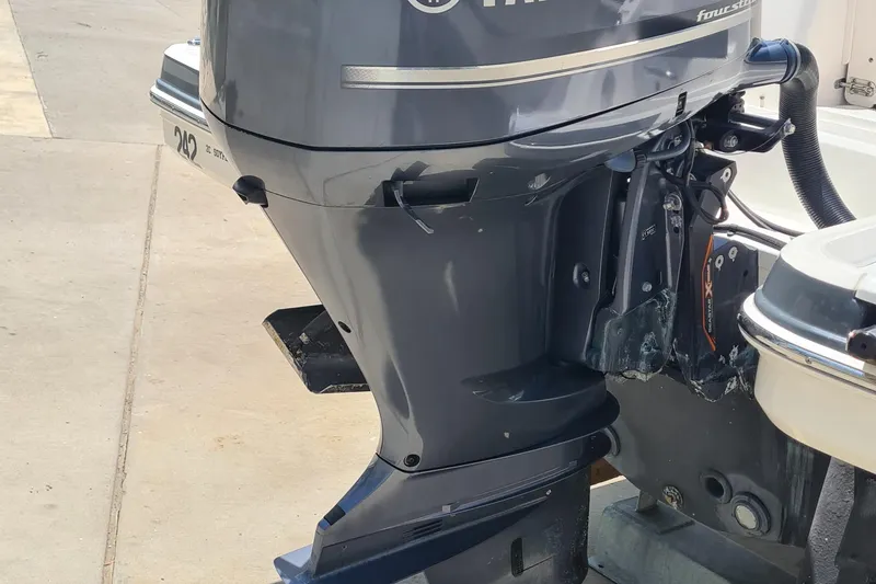 Slide: The Image of 2018 Chaparral Suncoast 250 Deluxe outboard motor, docked on a concrete surface. - 35