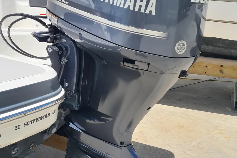 Slide: The Image of 2018 Chaparral Suncoast 250 Deluxe with Yamaha outboard motor, docked on concrete surface. - 36