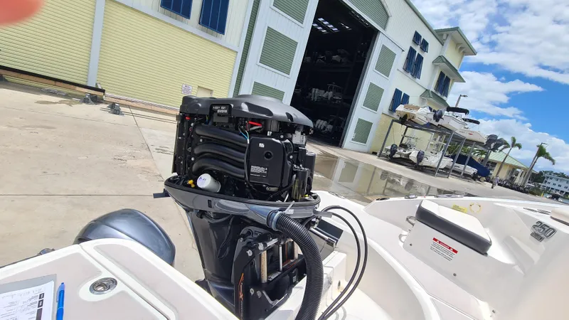 Slide: The Image of 2018 Chaparral Suncoast 250 Deluxe boat engine at marina, sunny day. - 37