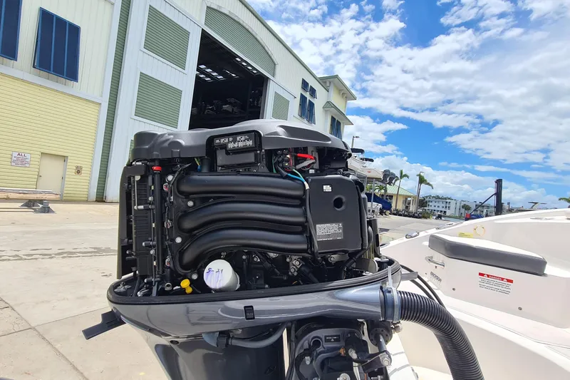 Slide: The Image of 2018 Chaparral Suncoast 250 Deluxe boat engine, outdoor marina setting, clear blue sky. - 40
