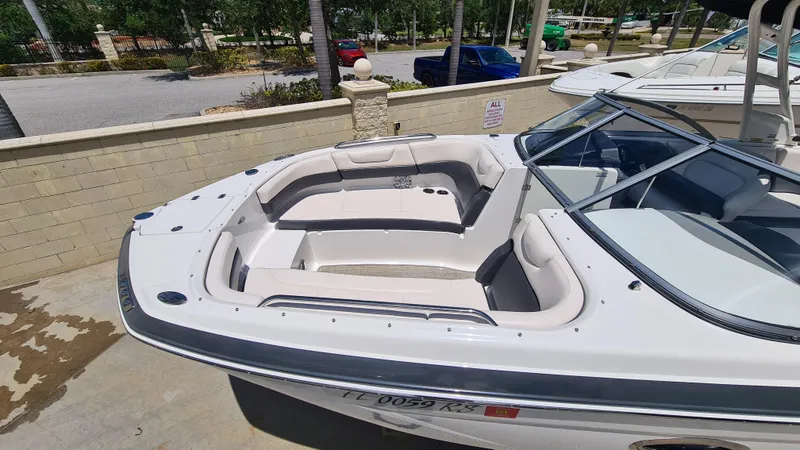 Slide: The Image of 2018 Chaparral Suncoast 250 Deluxe boat with spacious seating, docked outdoors. - 7