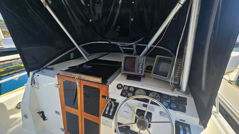 Slide: The Image of 1992 Luhrs Tournament 300 boat cockpit with steering wheel and navigation equipment. - 17