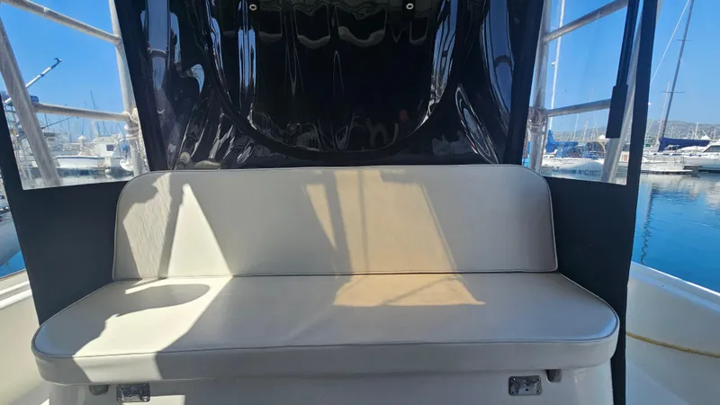 Slide: The Image of 1992 Luhrs Tournament 300 boat interior with cushioned seating and marina view. - 19
