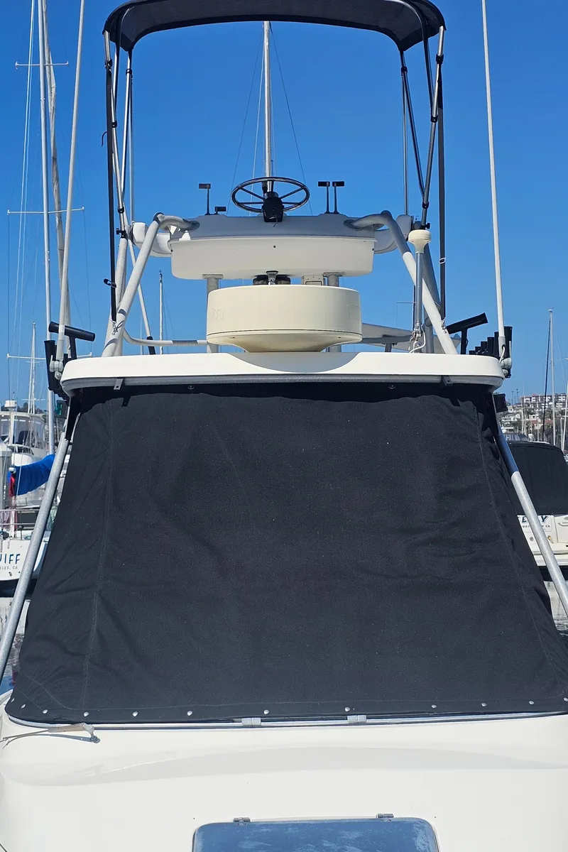 Slide: The Image of 1992 Luhrs Tournament 300 boat with flybridge and black canvas cover. - 2