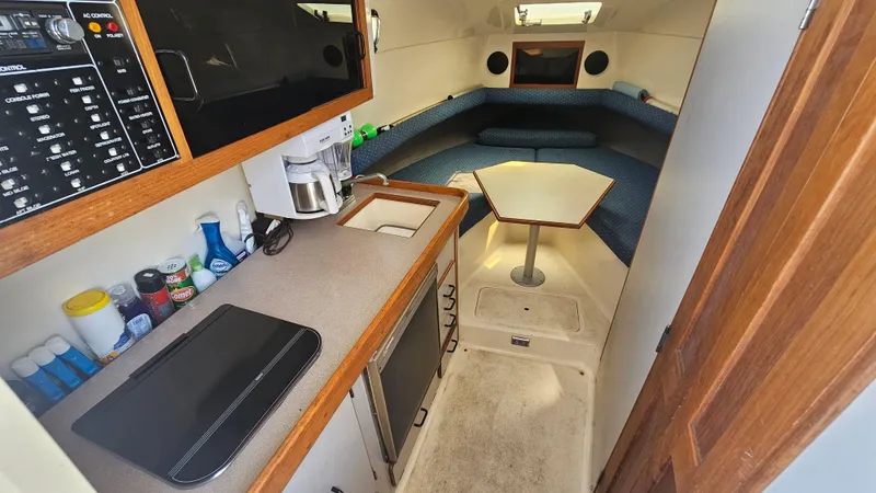 Slide: The Image of 1992 Luhrs Tournament 300 cabin interior with kitchenette and seating area. - 20