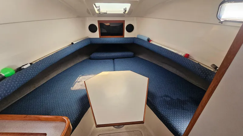 Slide: The Image of 1992 Luhrs Tournament 300 cabin interior with blue seating and overhead hatch. - 21