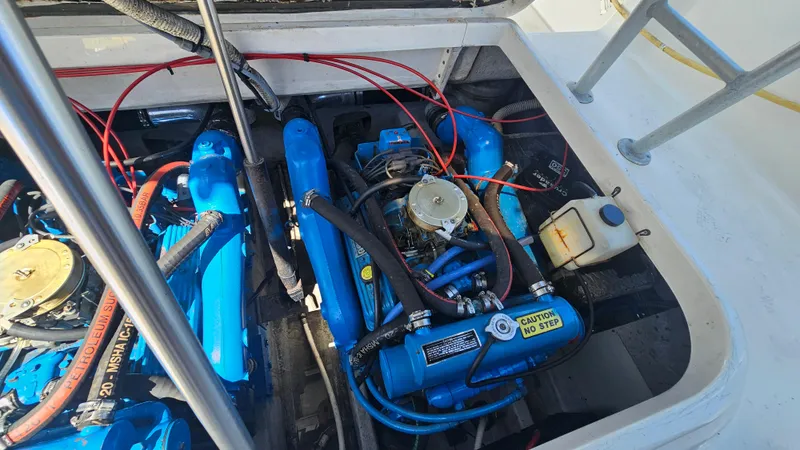 Slide: The Image of Engine compartment of a 1992 Luhrs Tournament 300 boat, featuring blue engine components. - 24