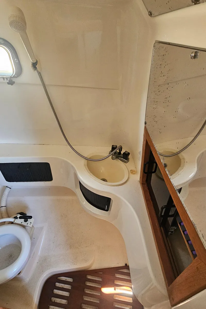 Slide: The Image of 1992 Luhrs Tournament 300 boat bathroom with shower, sink, and mirror. - 26