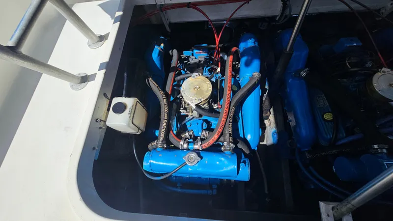 Slide: The Image of Engine compartment of a 1992 Luhrs Tournament 300 boat, featuring a blue marine engine. - 30