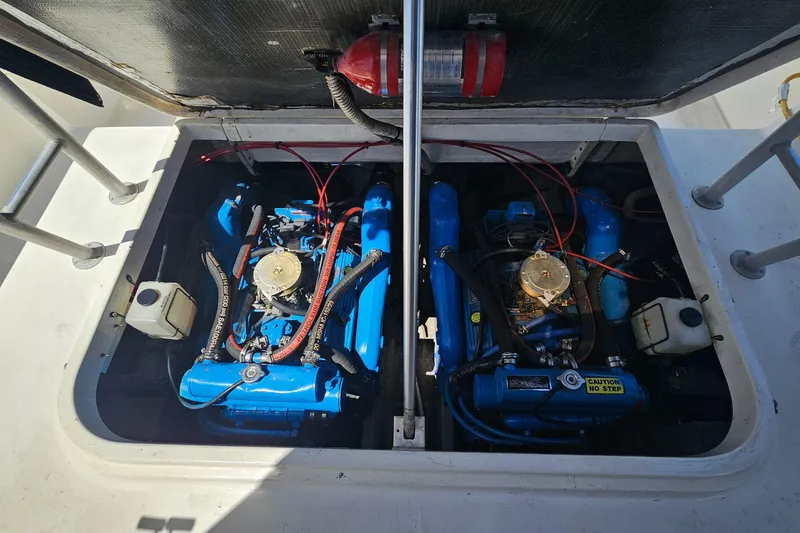Slide: The Image of Engine compartment of 1992 Luhrs Tournament 300 with dual blue engines and fire extinguisher. - 31