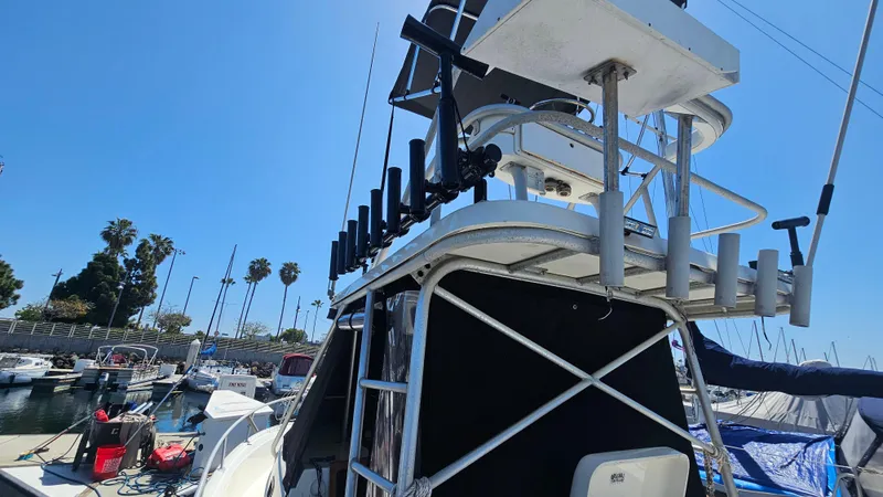 Slide: The Image of 1992 Luhrs Tournament 300 boat docked at marina with clear blue sky. - 7