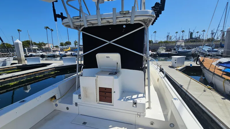 Slide: The Image of 1992 Luhrs Tournament 300 boat docked at marina, featuring open deck and helm station. - 9