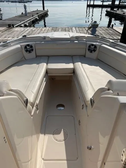 Slide: The Image of 2020 Grady-White Freedom 325 boat interior with beige seating at a dock. - 18
