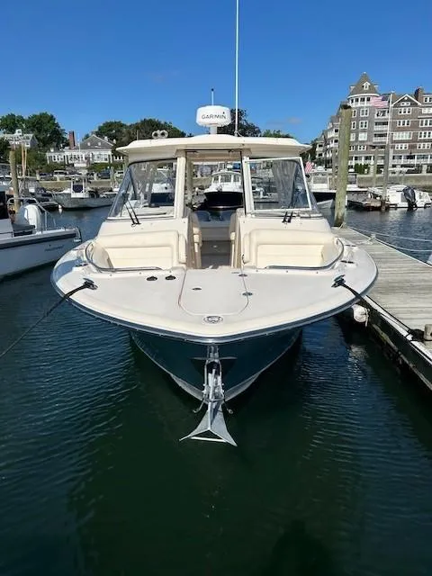 Slide: The Image of 2020 Grady-White Freedom 325 boat docked in a marina, front view. - 19