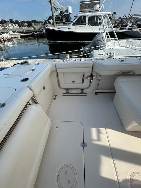 Slide: The Image of 2020 Grady-White Freedom 325 boat interior at marina, showcasing spacious seating and sleek design. - 22