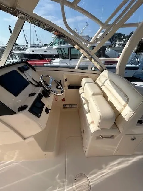 Slide: The Image of 2020 Grady-White Freedom 325 boat interior with helm and seating. - 24