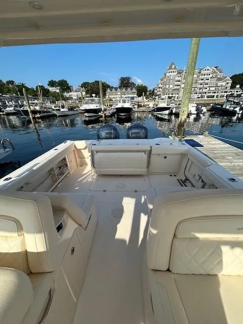 Slide: The Image of 2020 Grady-White Freedom 325 boat docked at a marina with luxury seating. - 25