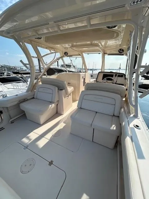 Slide: The Image of 2020 Grady-White Freedom 325 boat interior with plush seating at marina. - 26