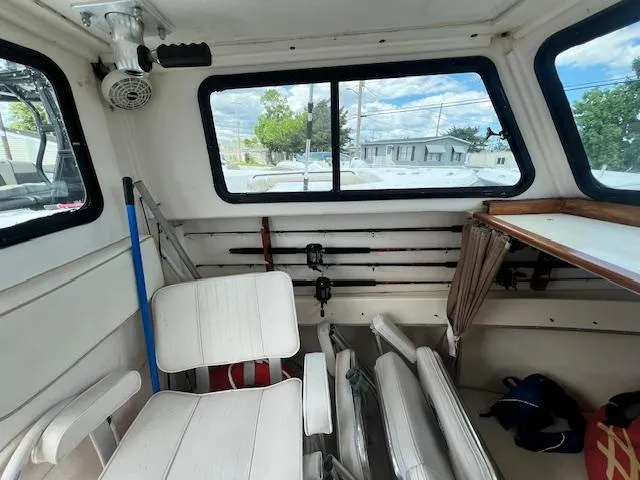 Slide: The Image of Interior of 1989 Parker 2520 Modified Vee Sport Cabin with fishing gear and seating. - 5