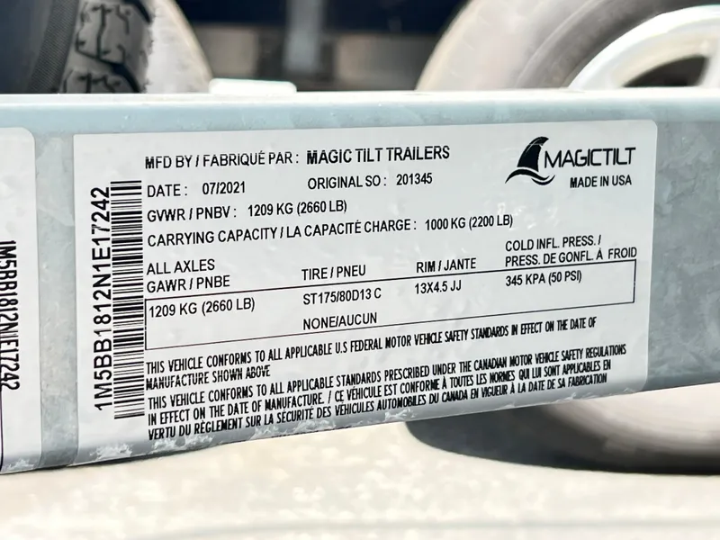 Slide: The Image of Magic Tilt trailer label with specifications and compliance details, manufactured in July 2021. - 11