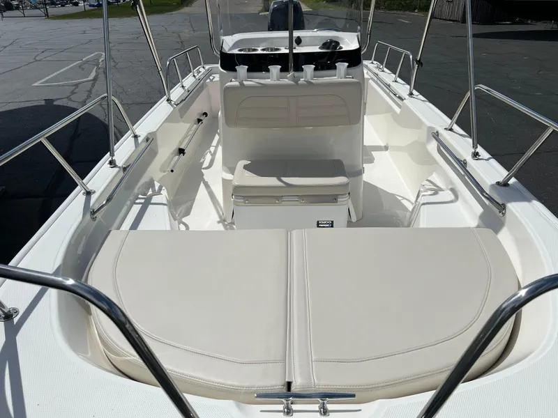 Slide: The Image of 2022 Boston Whaler 150 Montauk boat interior with seating and console. - 8
