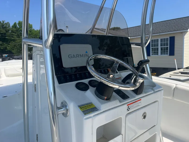 Slide: The Image of 2018 Sea Hunt Triton 225 boat console with Garmin navigation system and steering wheel. - 12