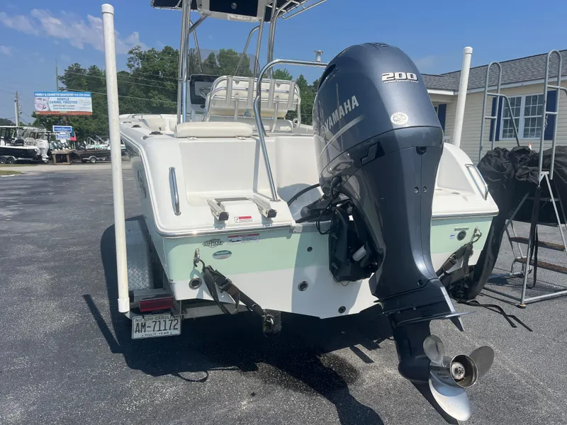 Slide: The Image of 2018 Sea Hunt Triton 225 boat with Yamaha 200 outboard motor, parked outdoors. - 3