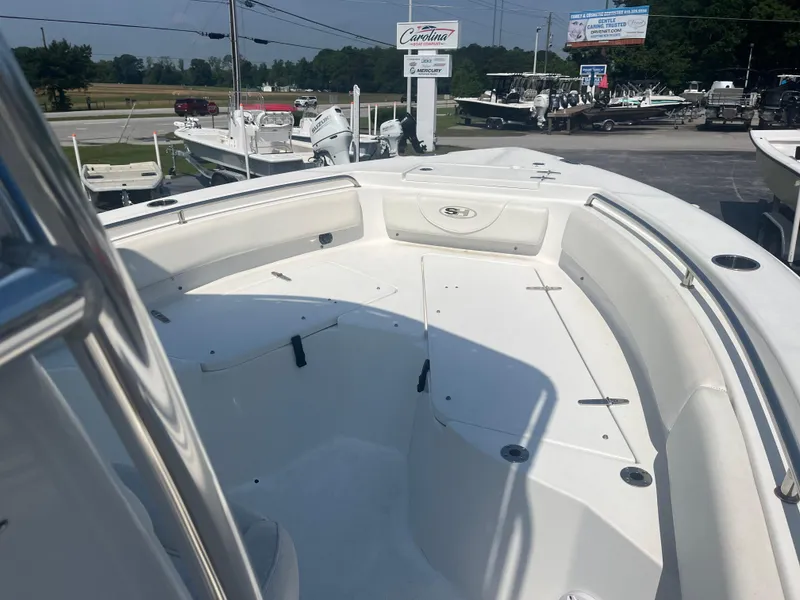 Slide: The Image of 2018 Sea Hunt Triton 225 boat interior, showcasing spacious seating and storage areas. - 4