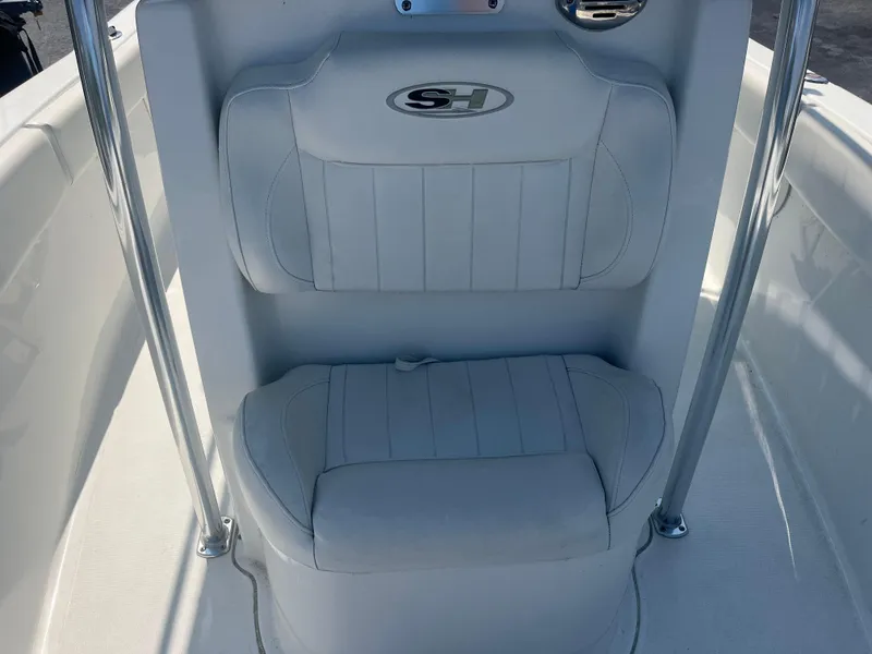 Slide: The Image of 2018 Sea Hunt Triton 225 boat seating with white cushioned upholstery. - 5