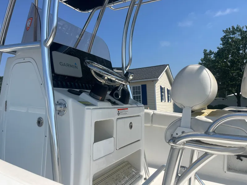 Slide: The Image of 2018 Sea Hunt Triton 225 boat interior with Garmin navigation system and seating. - 7