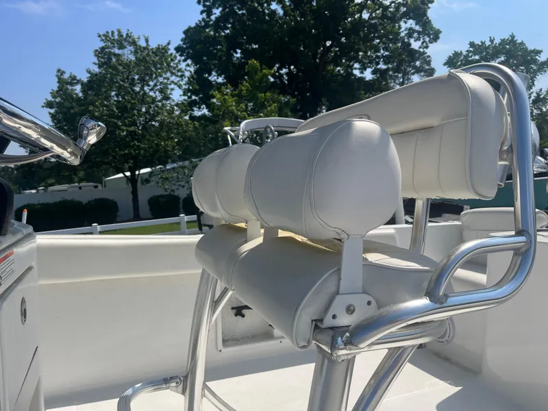 Slide: The Image of 2018 Sea Hunt Triton 225 boat with white cushioned seating and stainless steel frame. - 9