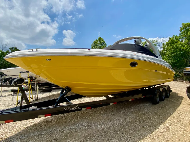 Slide: The Image of Yellow 2004 Sea Ray 290 SLX boat on trailer under blue sky. - 0