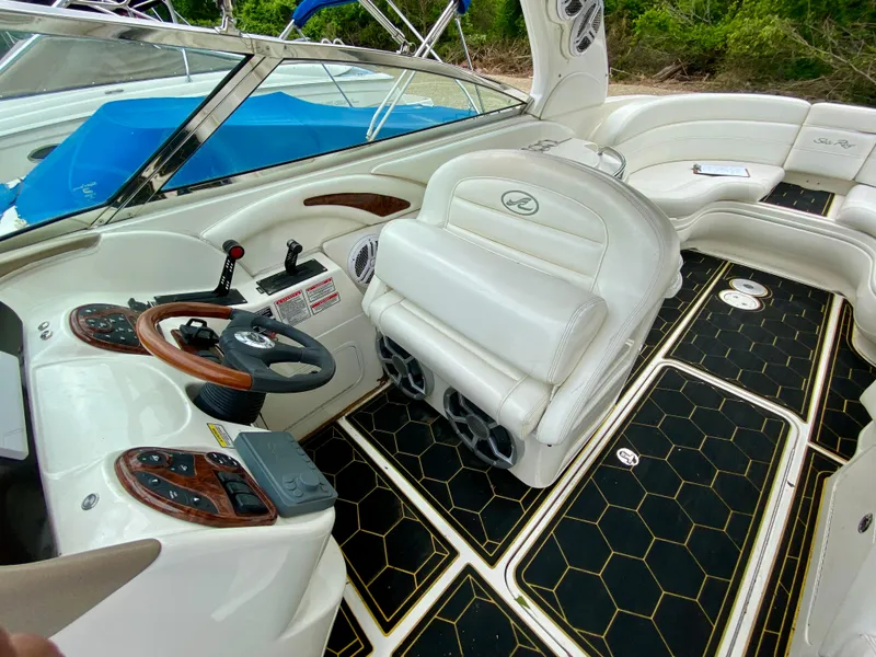 Slide: The Image of 2004 Sea Ray 290 SLX boat interior with white seating and black flooring. - 11