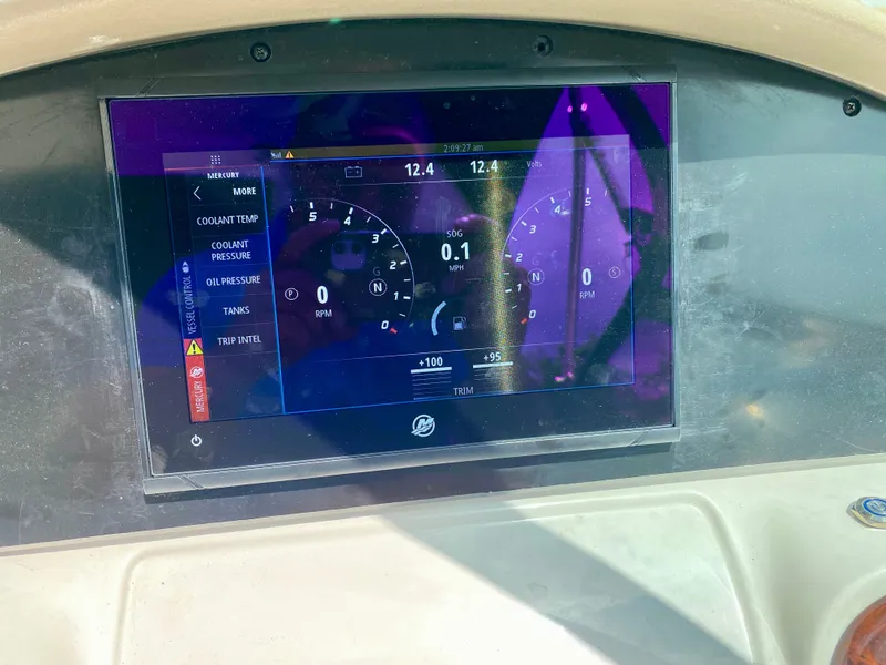 Slide: The Image of Dashboard display of a 2004 Sea Ray 290 SLX boat showing engine metrics. - 14